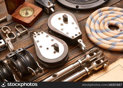 Sailing yacht rigging equipment on wooden background