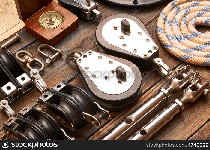 Sailing yacht rigging equipment on wooden background