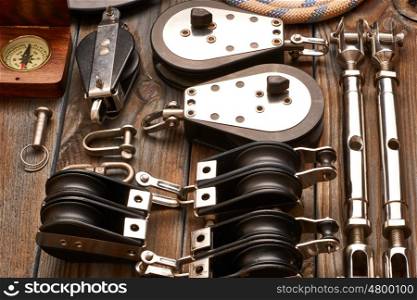 Sailing yacht rigging equipment on wooden background