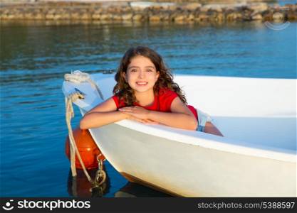 Sailor kid girl happy smiling relaxed in boat bow at Formentera Balearic Islands