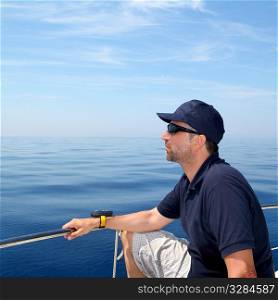 Sailor man sailing boat blue calm ocean water Mediterranean sea