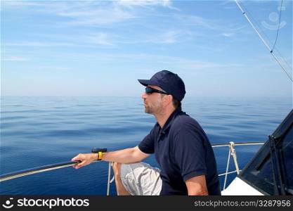 Sailor man sailing boat blue calm ocean water Mediterranean sea