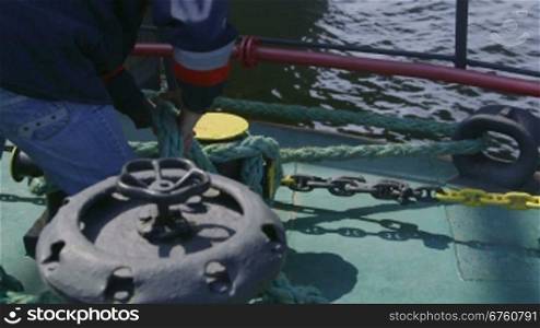 Sailor mooring vessel at offshore gas production platform