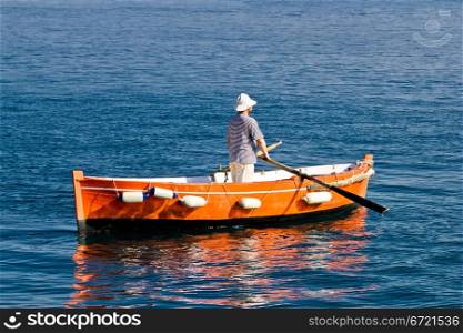 Sailor rowing on wooden taxi boat in Zadar, Croatia