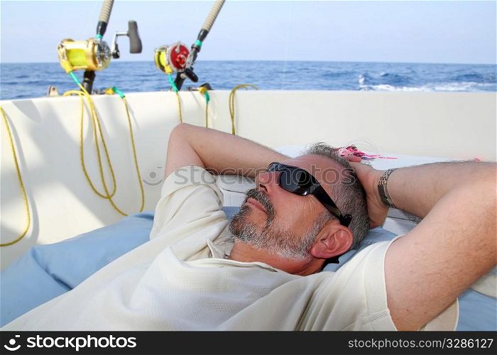 Sailor senior fisherman relax on boat fishing deep sea