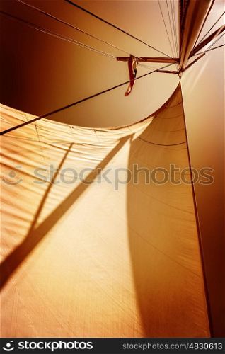 Sails in sunset light, dark orange sky background, summer adventure, traveling on luxury water transport, freedom and extreme sport concept