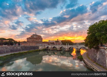 Saint Angel castle and bridge at sunrise, Rome. Saint Angel castle and bridge with mirror reflection in Tiber River during morning blue hour in Rome, Italy.