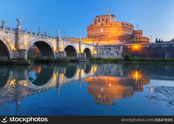 Saint Angel castle and bridge, Rome, Italy. Saint Angel castle and bridge and Saint Peter Cathedral with mirror reflection in Tiber River during morning blue hour in Rome, Italy.