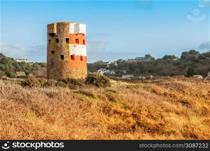 Saint Brelade British round coastal defence tower standing in the field, bailiwick of Jersey, Channel Islands