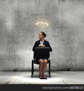 Saint businesswoman. Young crying businesswoman with halo above head