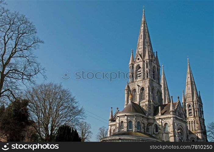 Saint Fin Barre&rsquo;s cathedral in Cork, Ireland (blue sky background)