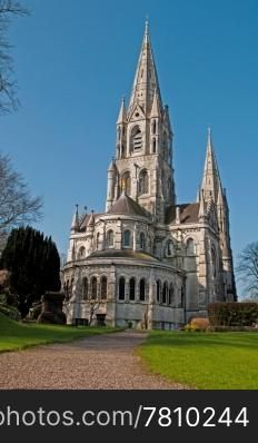 Saint Fin Barre&rsquo;s cathedral in Cork, Ireland (garden view and blue sky background)