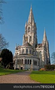 Saint Fin Barre&rsquo;s cathedral in Cork, Ireland (garden view and blue sky background)