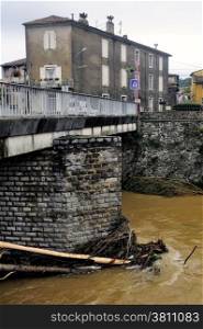 Saint-Hippolyte-du-Fort, a small French town in the foothills of the Cevennes Gard along the river Vidourle The swollen after heavy rains trees have blocked the bridge pier.