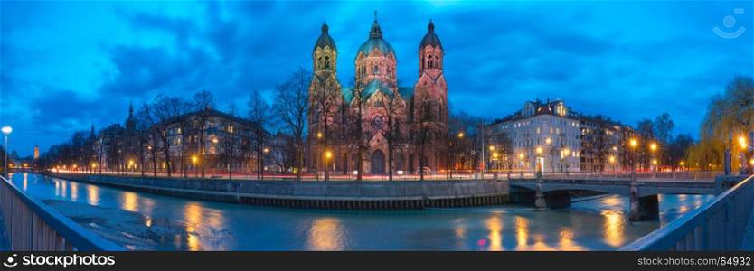 Saint Lucas Church at night in Munich, Germany. Panorama of Saint Lucas Church, the largest Protestant church in Munich, and Isar River at night, Bavaria, Germany