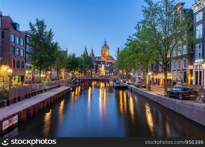 Saint Nicholas Church at night in Amsterdam city, Netherlands.