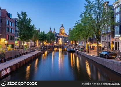 Saint Nicholas Church at night in Amsterdam city, Netherlands.
