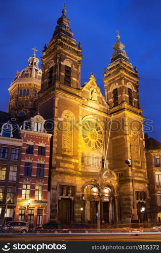 Saint Nicholas Church (Dutch: Sint Nicolaaskerk) illuminated at night in Amsterdam, Holland, Netherlands.