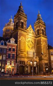 Saint Nicholas Church (Dutch: Sint Nicolaaskerk) illuminated at night in Amsterdam, Holland, Netherlands.