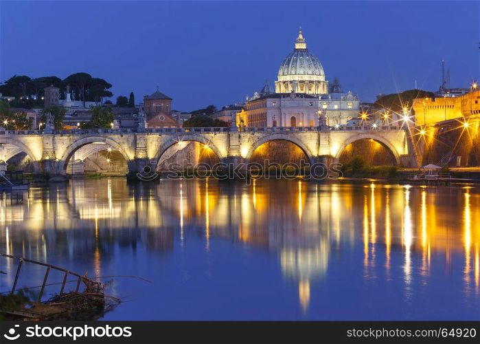 Saint Peter Cathedral at night in Rome, Italy.. Saint Angel bridge and Saint Peter Cathedral with a mirror reflection in the Tiber River during morning blue hour in Rome, Italy.