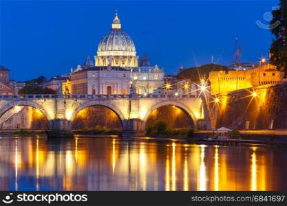 Saint Peter Cathedral at night in Rome, Italy.. Saint Angel bridge and Saint Peter Cathedral with a mirror reflection in the Tiber River during morning blue hour in Rome, Italy.