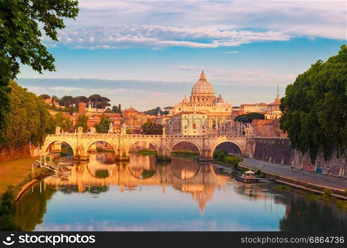 Saint Peter Cathedral in the morning, Rome, Italy.. Saint Angel bridge and Saint Peter Cathedral with a mirror reflection in the Tiber River in the sunny morning in Rome, Italy.