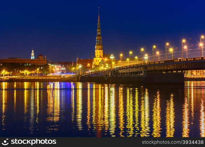 Saint Peter church, Stone Bridge and River Daugava in the Old Town of Riga at night, Latvia