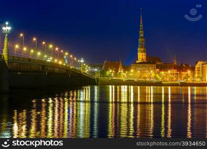 Saint Peter church, Stone Bridge and River Daugava in the Old Town of Riga at night, Latvia