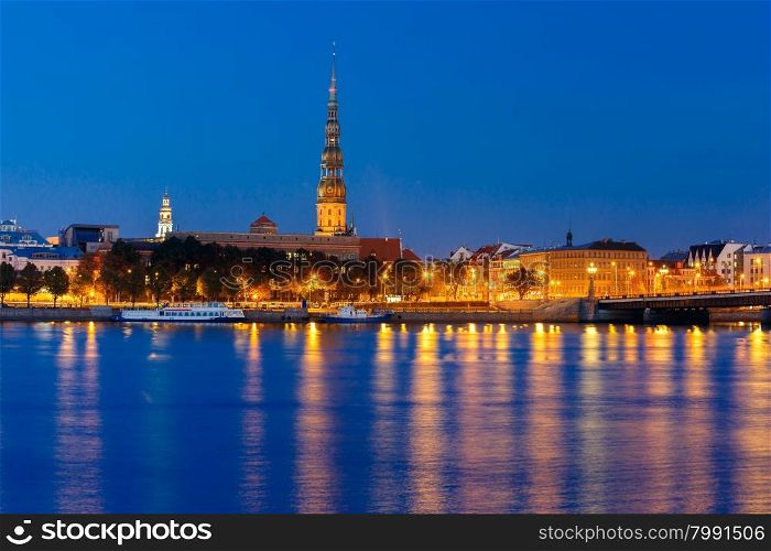 Saint Peter church, Stone Bridge and River Daugava in the Old Town of Riga at night, Latvia