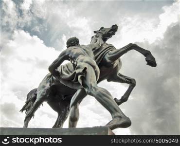 Saint-Petersburg sculpture: The Horse Tamers, designed by the Russian sculptor, Baron Peter Klodt von Urgensburg. Anichkov bridge, Saint-Petersburg, Russia