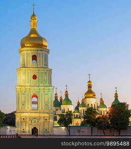 Saint Sophia’s Cathedral with bell tower view at twilight, blooming chestnut trees and afterglow sky in background, Kyiv, Ukraine