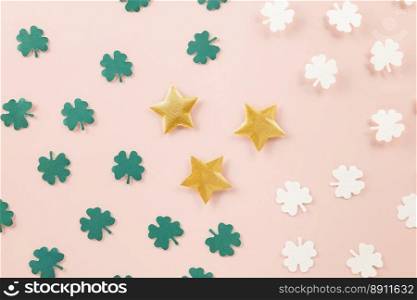 Saint St Patrick’s Day. Top view flat lay of paper cut clover leaves festive decor, shamrocks leaf holiday symbol with copy space on colour background, Banner greeting card good lucky concept