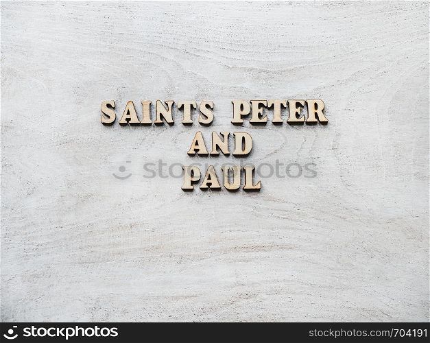 Saints Peter and Paul. Wooden, unpainted letters on a white table. Close-up, top view. Beautiful photo. Congratulations for loved ones, family, relatives, friends and colleagues. Saints Peter and Paul. Wooden, unpainted letters
