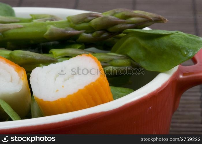 salad. a close up photo of a salad with asparagus and surimi