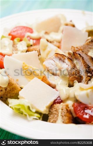 Salad Caesar in a white plate on the table. Salad Caesar in a plate