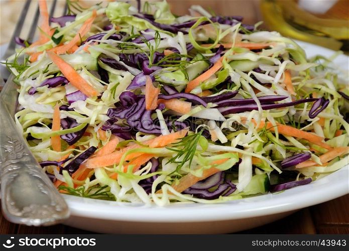 Salad coleslaw red and white cabbage with carrots and cucumber