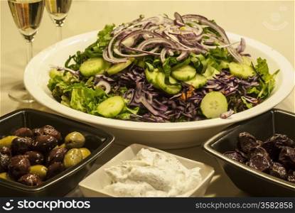 Salad dish, olives, caviar,white wine glasses