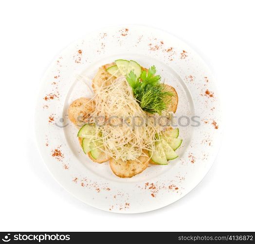 Salad dish with dried crust, vegetables, greens and cheese
