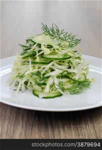 Salad finely chopped cabbage with cucumber and dill