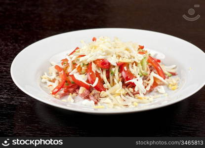 Salad from beef tongue, cervelat, chicken meat, fresh tomatoes, cucumbers, pepper, eggs, cheese and mayonnaise