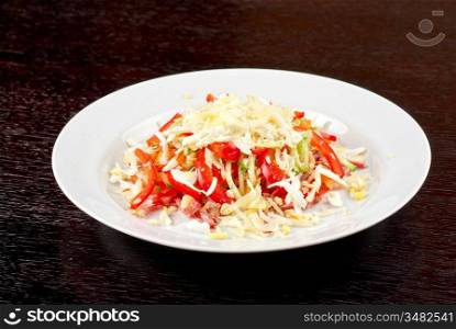 Salad from beef tongue, cervelat, chicken meat, fresh tomatoes, cucumbers, pepper, eggs, cheese and mayonnaise