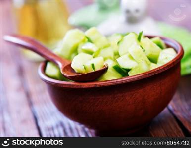 salad from cucumbers in the brown bowl