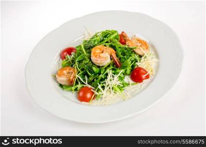 Salad from eruca and shrimps a white background