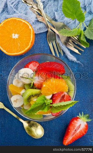 salad from fresh fruit in the glass bowl