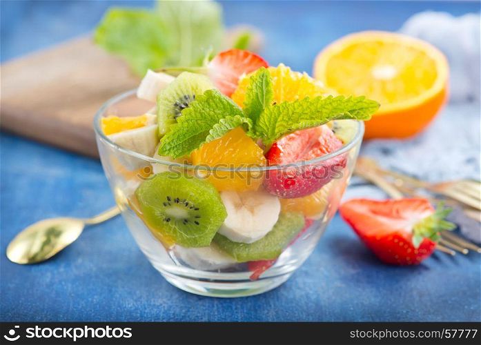 salad from fresh fruit in the glass bowl