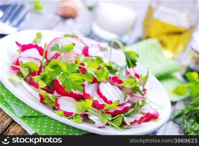 salad from radish on the plate and on a table