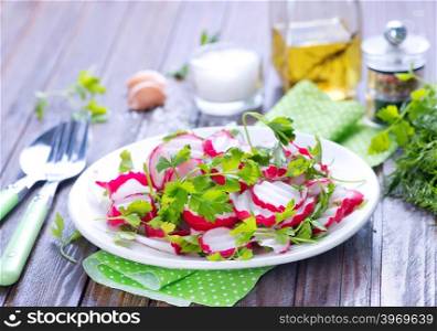 salad from radish on the plate and on a table