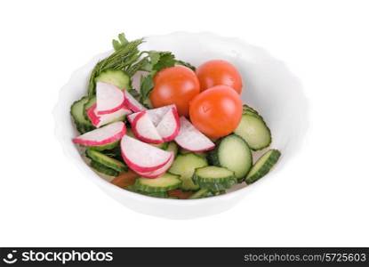Salad from tomatoes cucumbers and radish on white