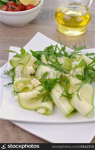 Salad from zucchini ribbon with arugula and feta