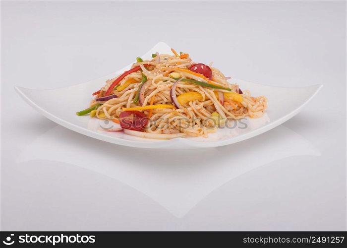 salad in a white plate on a white background. salad in a white plate